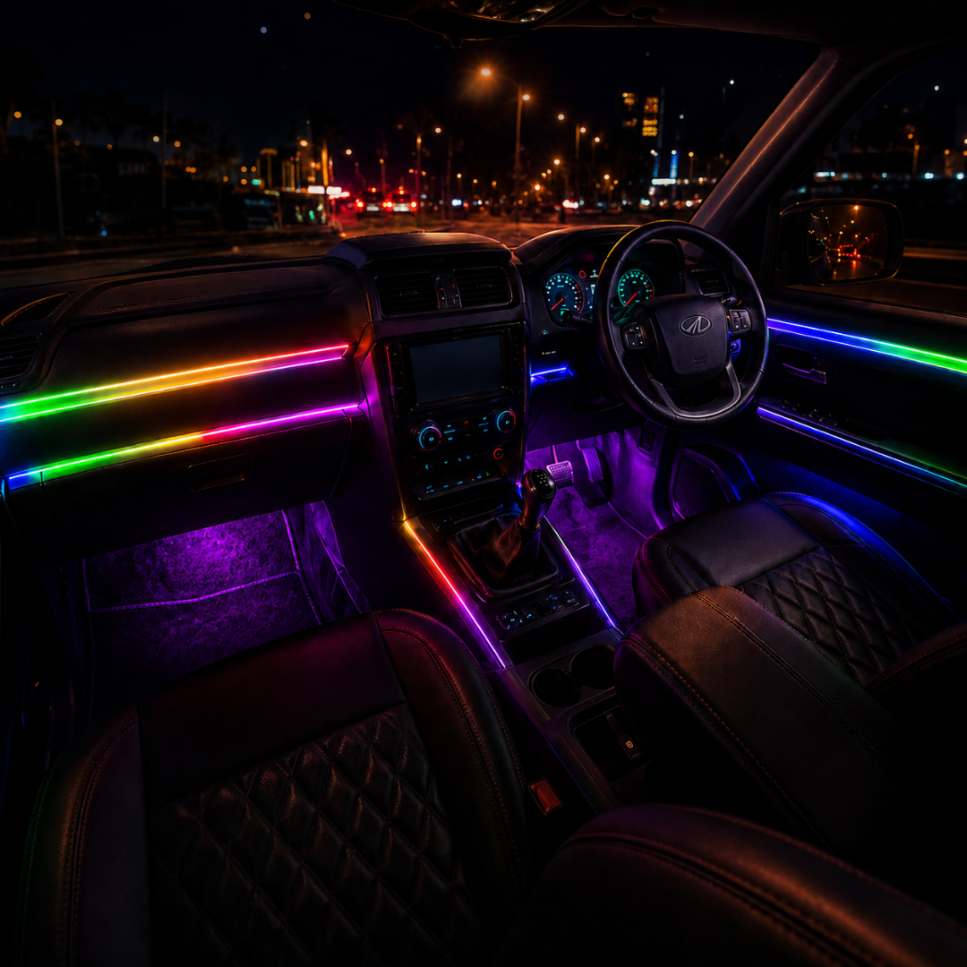 Nighttime cabin perspective view of Mahindra Scorpio S11 showing custom dashboard, door trim, center console, and footwell RGB ambient light glow.